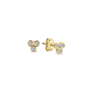3 diamond bezel stud earrings in yellow gold. 