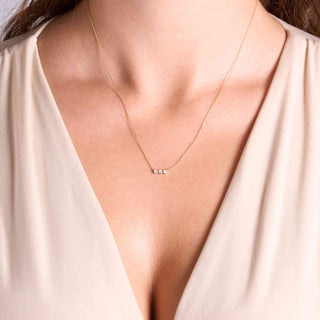 Model wearing a bezel diamond necklace