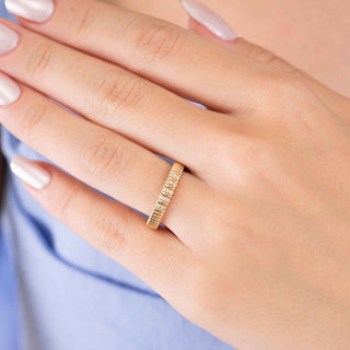Textured grooved diamond band in 14k gold worn on finger