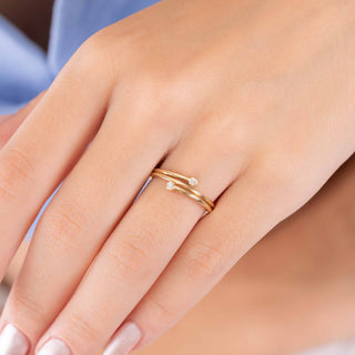 Gold dainty ring with two diamonds and a spiral design 