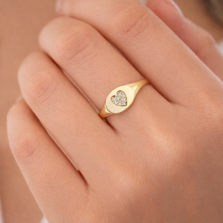 Pavé diamond heart signet ring in 14k gold worn on finger