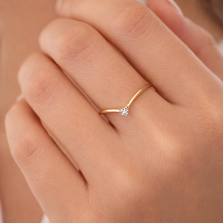 Sleek chevron diamond ring in 14k gold stacked on finger