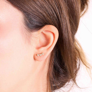 Diamond heart earrings worn in the lobe