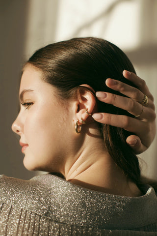 Sculptural ear cuff in 14k gold worn on upper ear